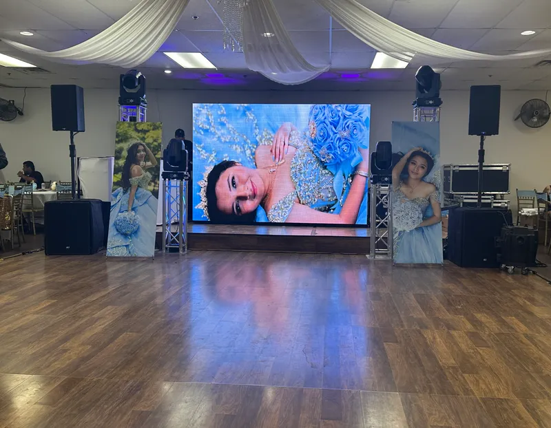 Blue-themed LED video wall and matching printed portrait banners at a DJ Oso quinceañera in Dallas-Fort Worth